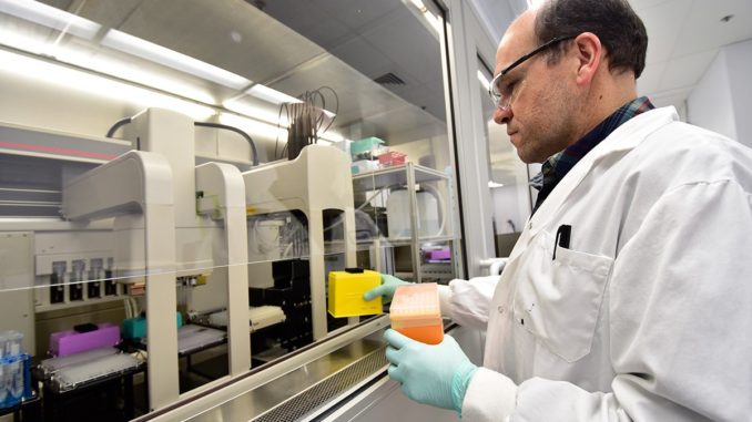 technician working in a lab to advance cancer treatment