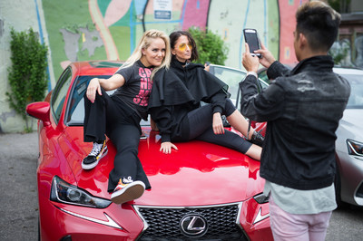 Two ladies sitting on a Lexus car for Toronto News