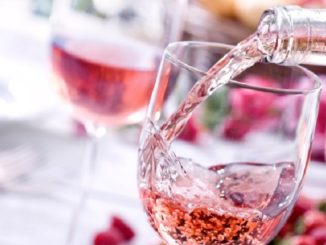 Rose wine pouring in a glass